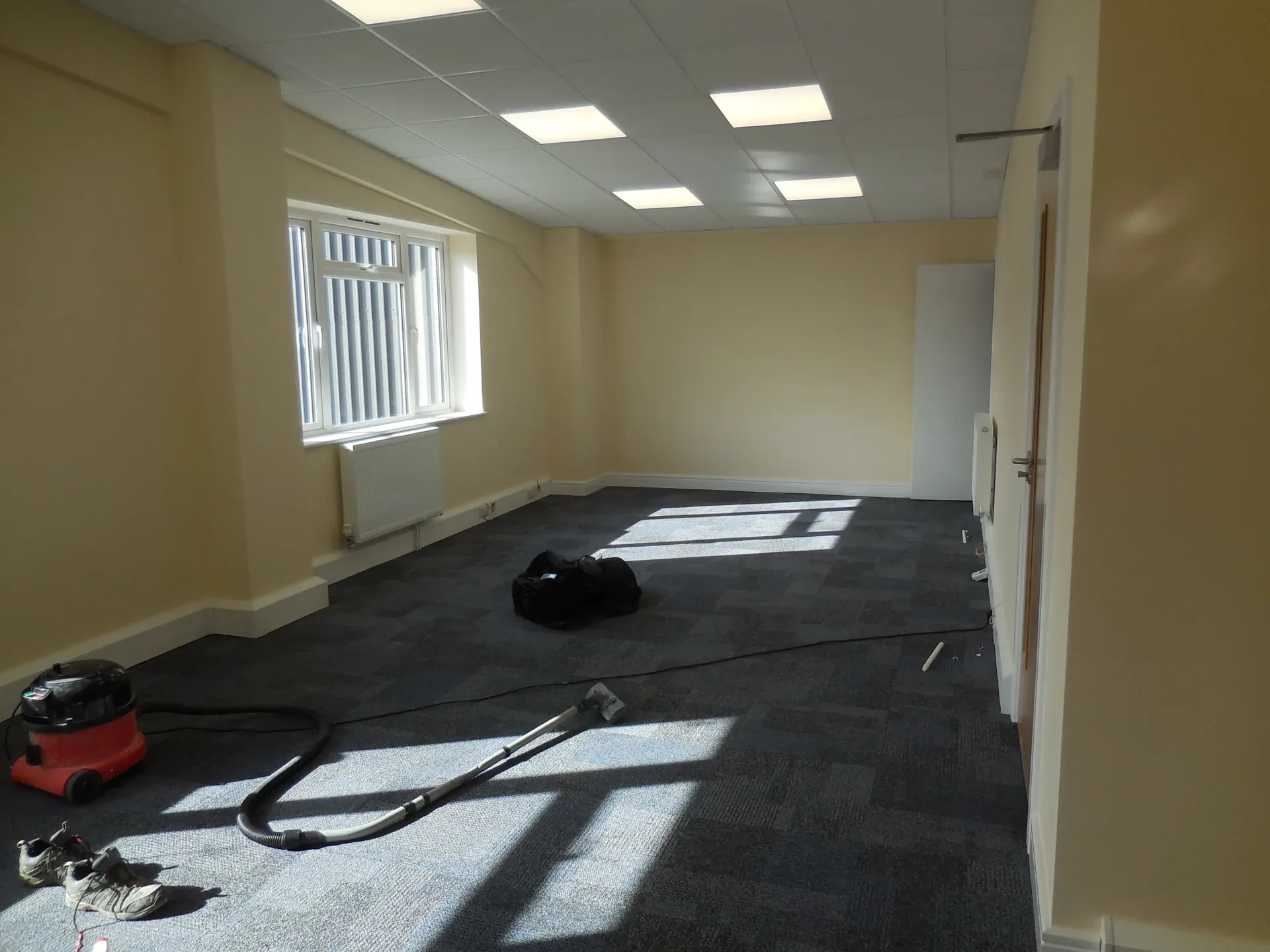 Large carpeted office suite with natural sunlight